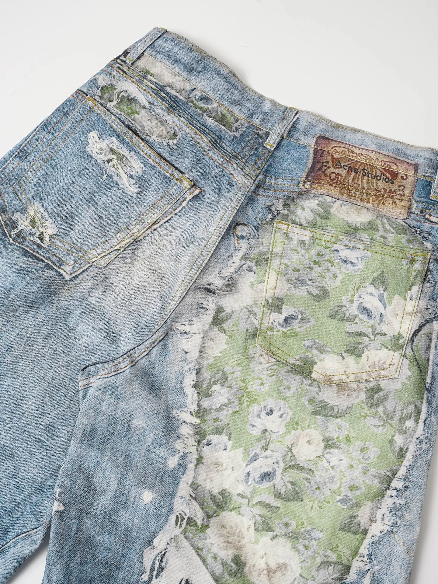 Acne Studios M ripped rose print trousers This season is guided by "multi-faceted self-perception" and deconstructs and reorganizes the core element of the rose. This pair of M jeans abandons the traditional flat embroidery and adopts a highly saturated broken rose oil painting print. It combines splash ink and mud-dyed textures to reconstruct a strong visual art on the denim surface, using the brand's iconic Trompe Loeil's trompe l'oeil printing technology "prints" roses on the trousers. From a distance, it looks like a three-dimensional superposition and peeling oil painting texture. From a closer look, you can feel the original fabric texture of denim, achieving a balance between visual thickness and lightweight wearing. It uses low-elastic brushed denim fabric (to make it easier to wear). Good support for 3D printed three-dimensional effect), with Classic five-pocket structure, button placket and leather back brand logo, mid-low-rise straight trousers, and the upper body has a Nordic Retro and high-street lazy atmosphere. It is a core item for summer layering, Citywalk and street style. Size: S-XL